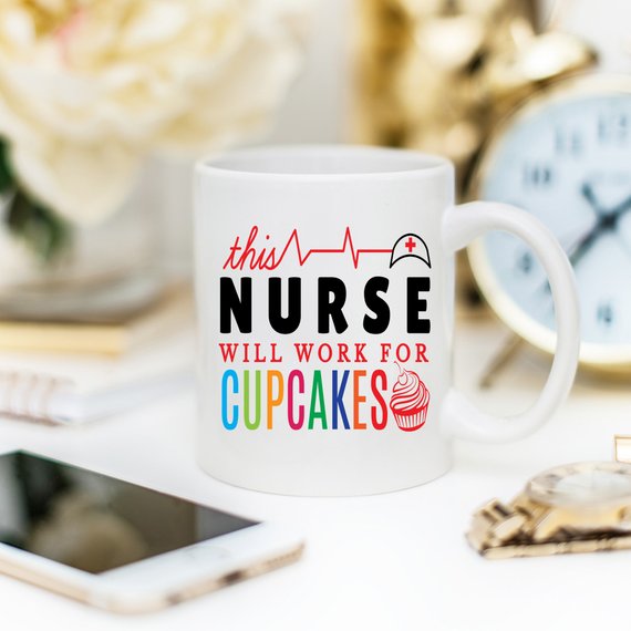 A high-quality ceramic coffee mug featuring the humorous text 'This Nurse Will Work For Cupcakes', perfect for nurses and coffee lovers.