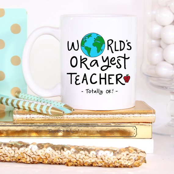 Funny Teacher Gift Mug featuring the 'World's Okayest Teacher' design, perfect for coffee lovers.