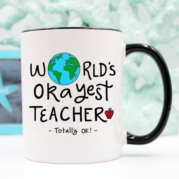 Funny Teacher Gift Mug featuring the 'World's Okayest Teacher' design, perfect for coffee lovers.