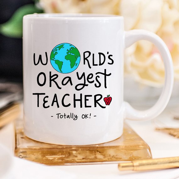 Funny Teacher Gift Mug featuring the 'World's Okayest Teacher' design, perfect for coffee lovers.