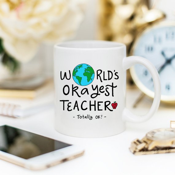 Funny Teacher Gift Mug featuring the 'World's Okayest Teacher' design, perfect for coffee lovers.