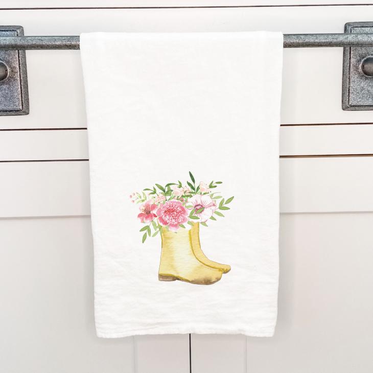 Garden Boots cotton tea towel featuring vibrant designs, made from 100% absorbent cotton, displayed on a kitchen countertop.