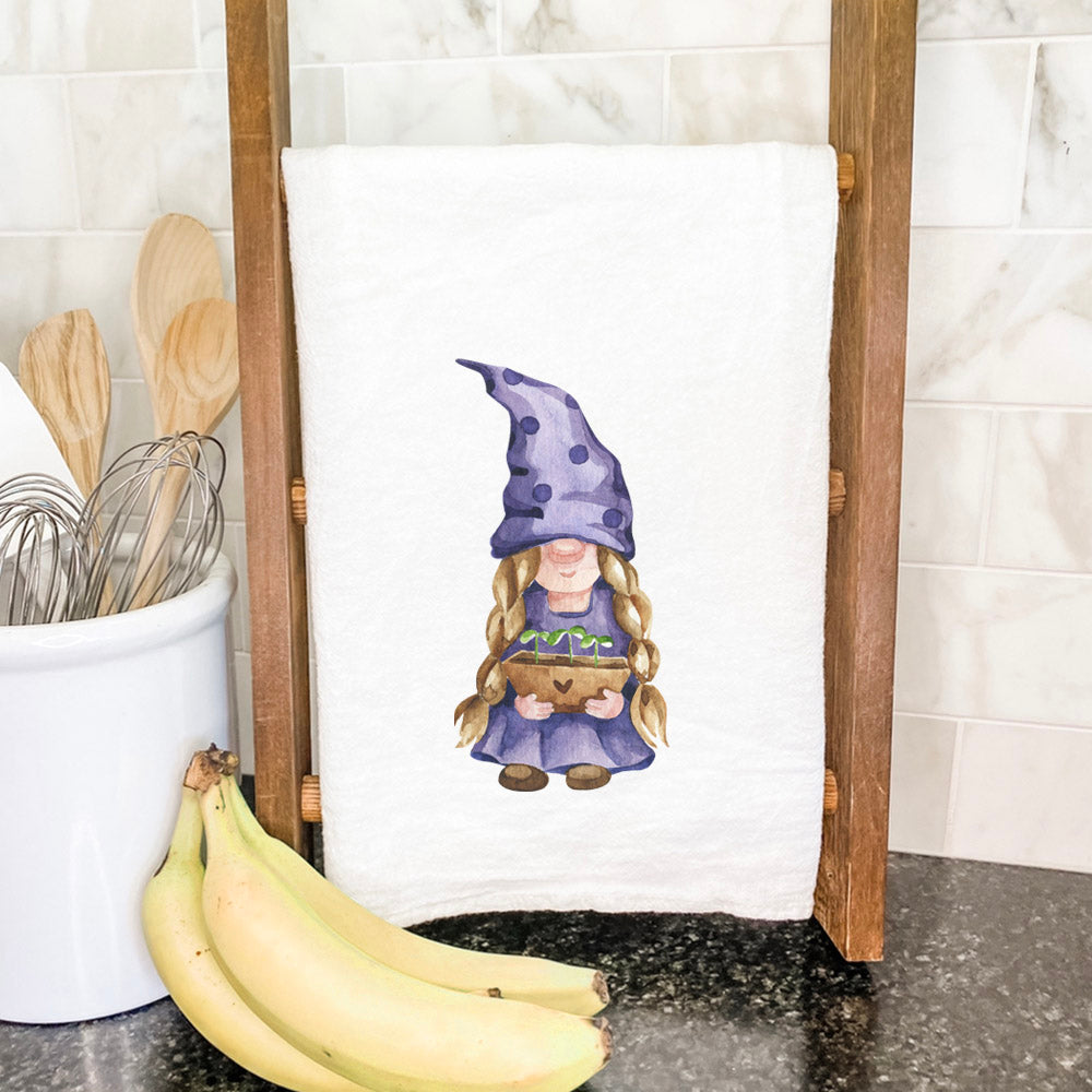 A colorful cotton tea towel featuring a whimsical garden gnome surrounded by sprouts, perfect for kitchen use.