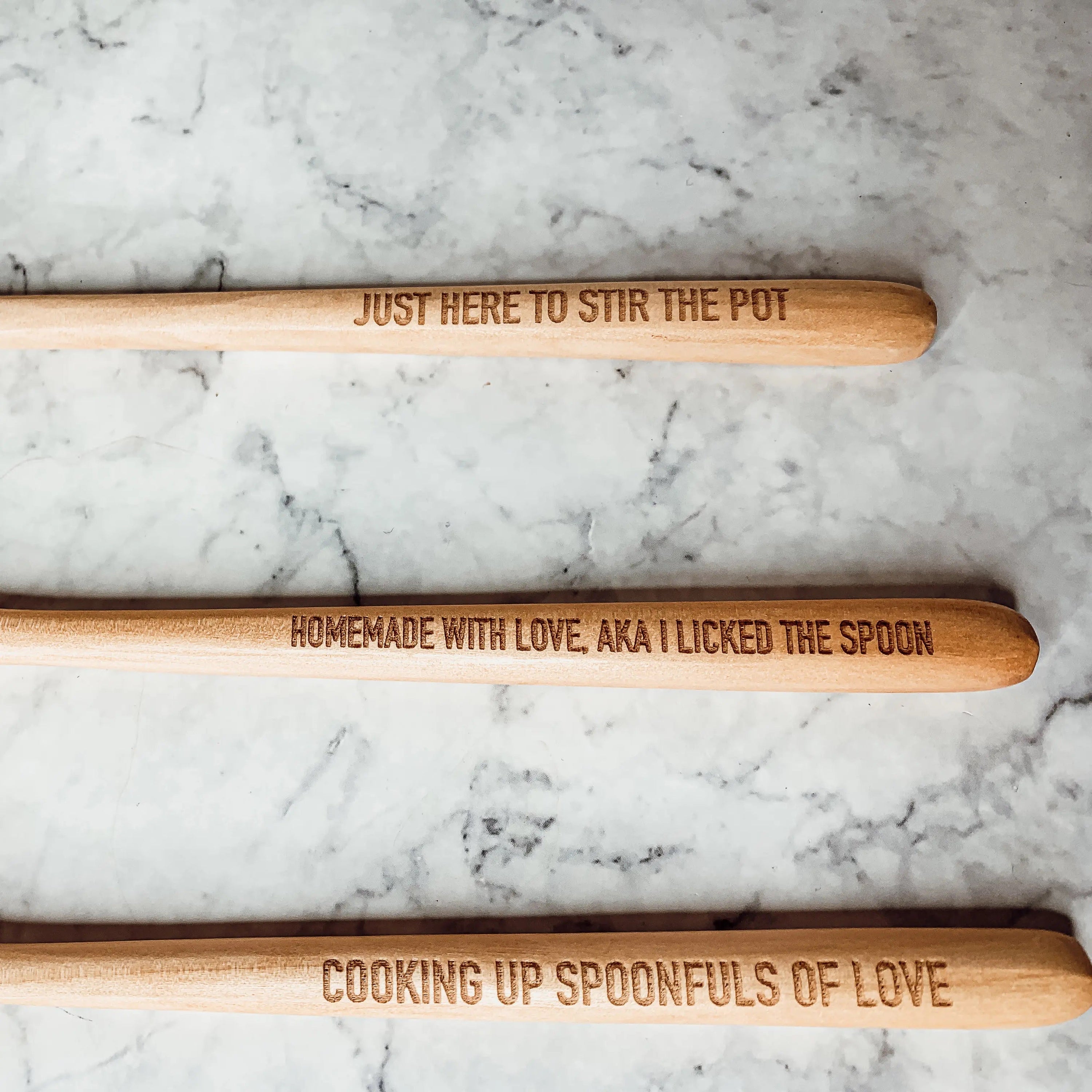 Give it a Rest LG NEW spoon rest and wooden spoon set featuring colorful designs and fun quotes, perfect for keeping kitchens clean.