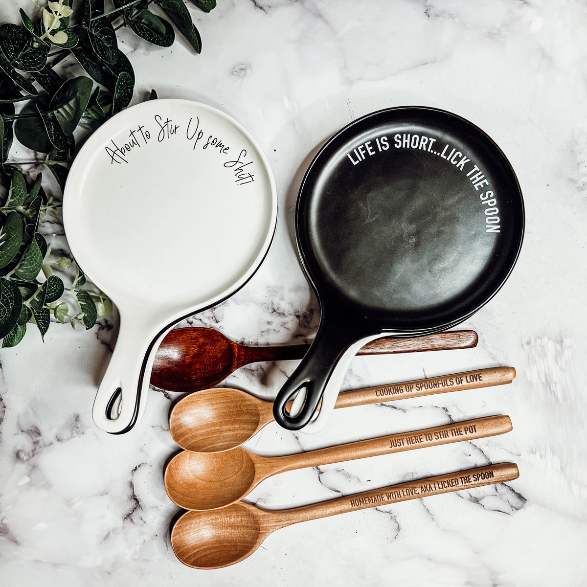 Give it a Rest LG spoon rest and wooden spoon set featuring various colors and fun quotes, perfect for keeping your kitchen clean.