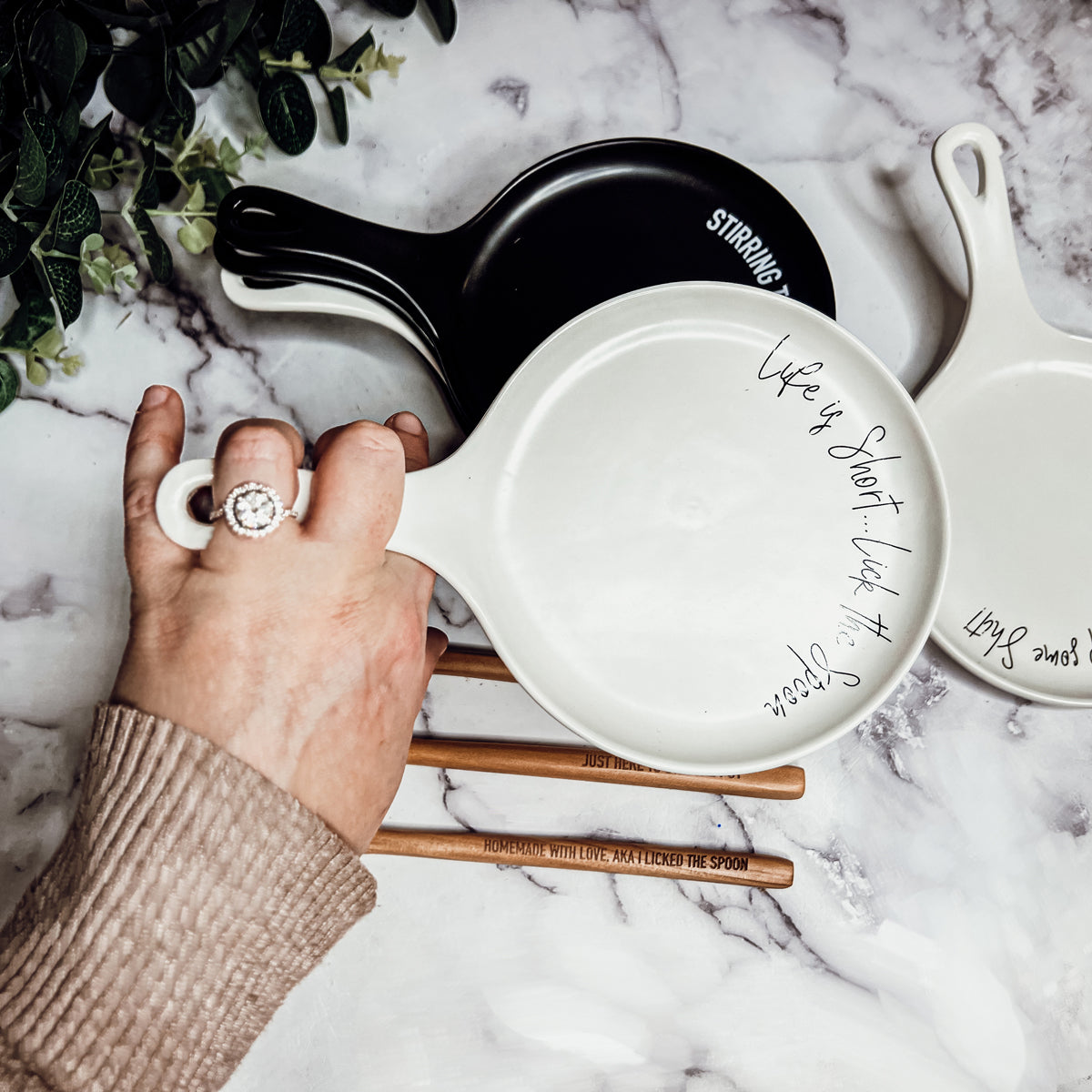 Give it a Rest LG spoon rest and wooden spoon set featuring various colors and fun quotes, perfect for keeping your kitchen clean.