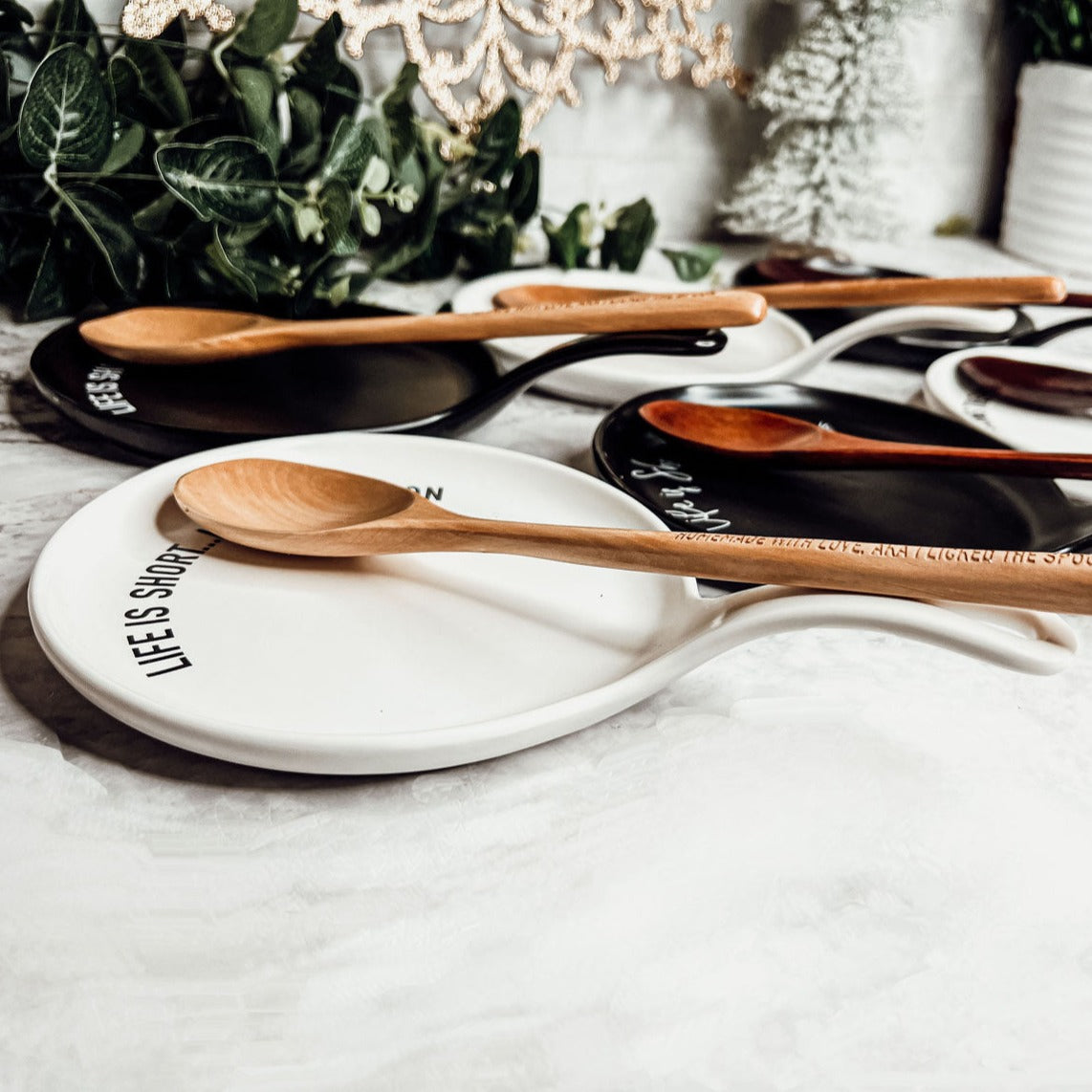 Give it a Rest LG spoon rest and wooden spoon set featuring various colors and fun quotes, perfect for keeping your kitchen clean.