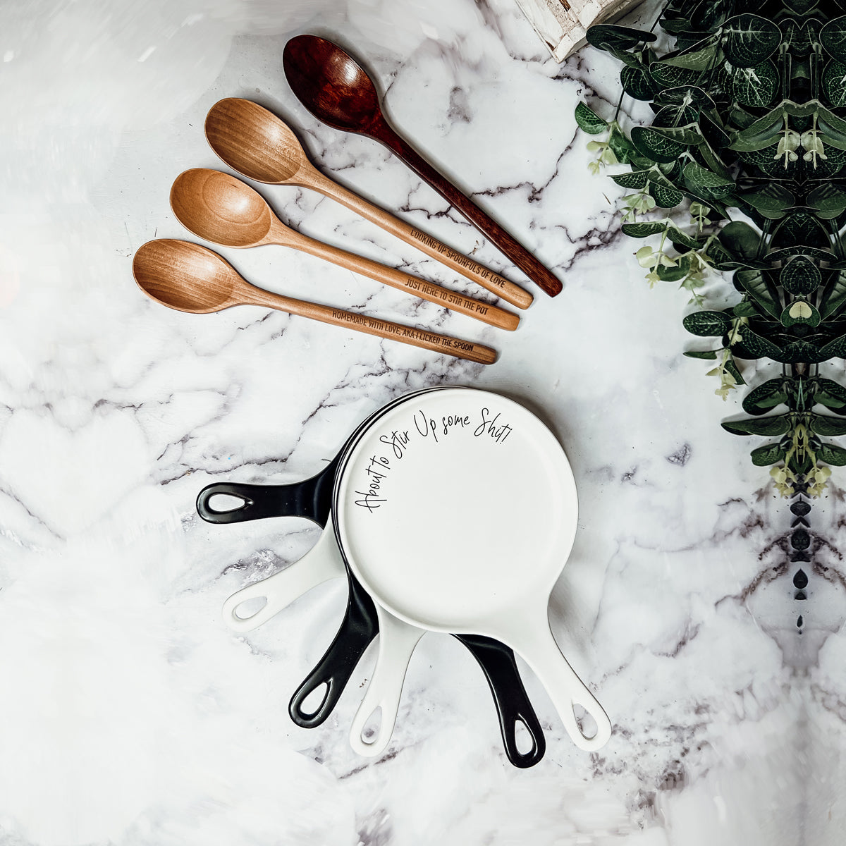 Give it a Rest LG spoon rest and wooden spoon set featuring various colors and fun quotes, perfect for keeping your kitchen clean.