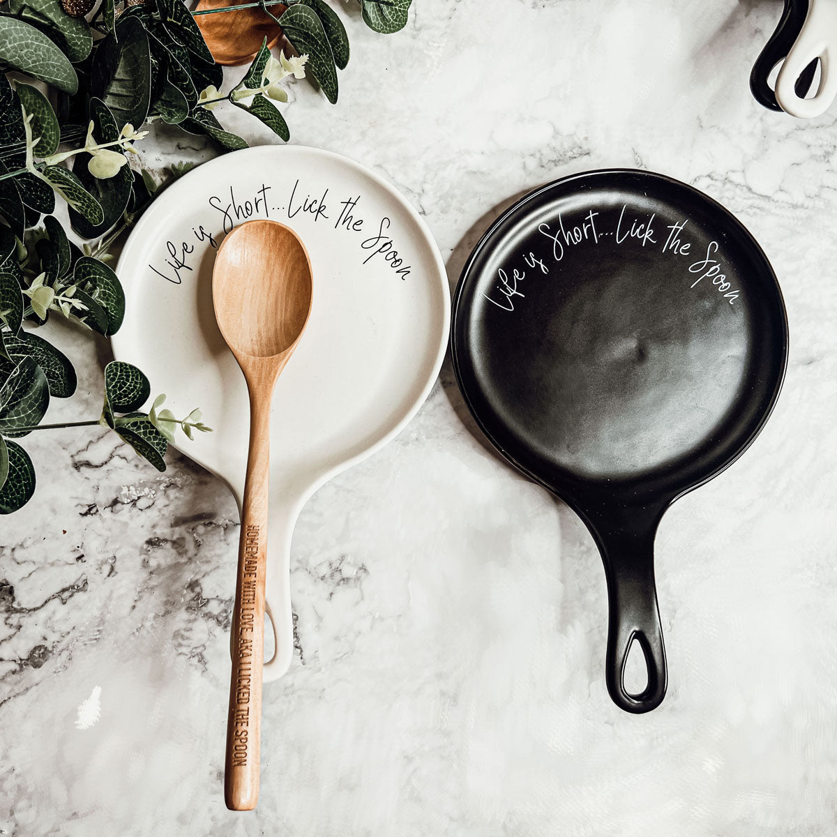 Give it a Rest LG spoon rest and wooden spoon set featuring various colors and fun quotes, perfect for keeping your kitchen clean.