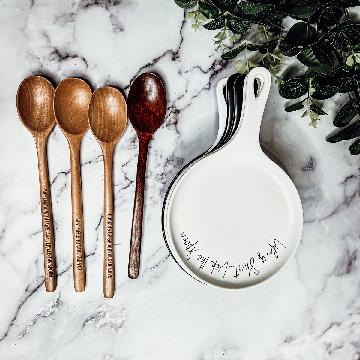 Give it a Rest LG spoon rest and wooden spoon set featuring various colors and fun quotes, perfect for keeping your kitchen clean.