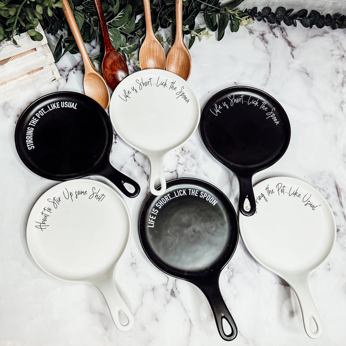 Give it a Rest LG spoon rest and wooden spoon set featuring various colors and fun quotes, perfect for keeping your kitchen clean.