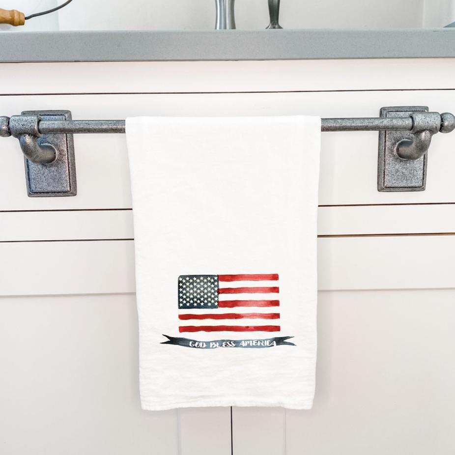 God Bless America Flag cotton tea towel featuring vibrant colors and hemmed edges, perfect for kitchen use.