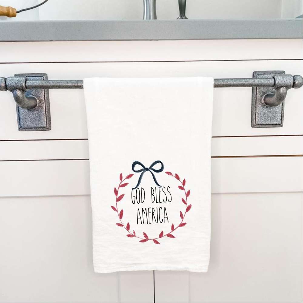 God Bless America Wreath cotton tea towel featuring vibrant colors and a patriotic design, perfect for kitchen use.