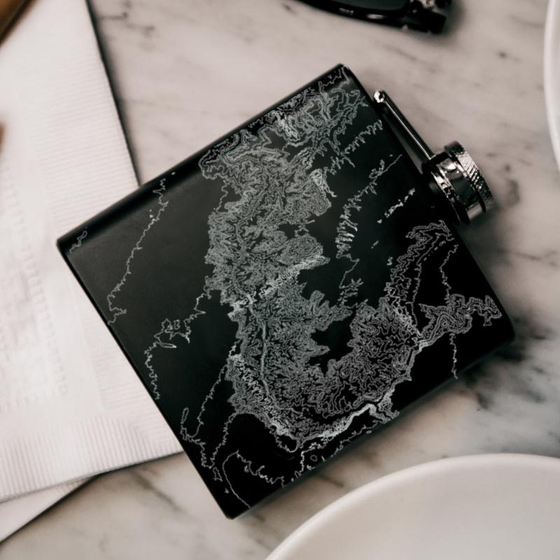 Matte black hip flask featuring a custom engraved map of Grand Canyon National Park, Arizona, with coordinates.