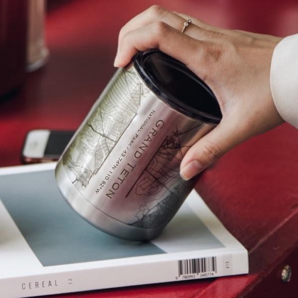 A 10oz double-walled insulated stainless steel cup featuring a custom engraved map of Grand Teton National Park, Wyoming.