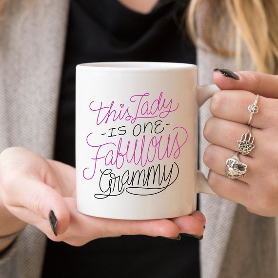 A humorous coffee mug featuring the phrase 'This Lady Is One Fabulous Grammy', designed for grandmothers, made of high-quality ceramic.