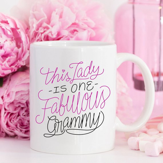 A humorous coffee mug featuring the phrase 'This Lady Is One Fabulous Grammy', designed for grandmothers, made of high-quality ceramic.