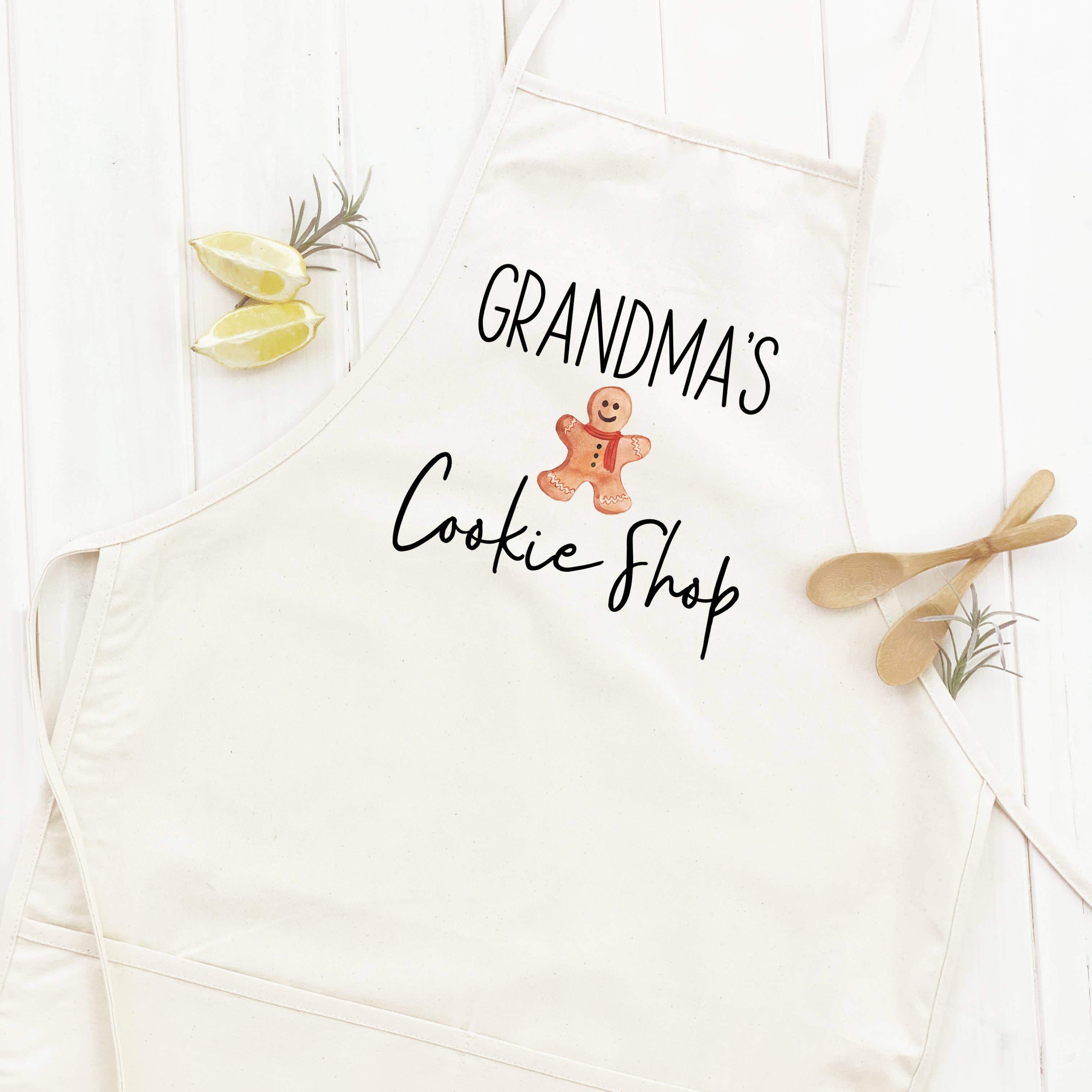 A stylish women's apron from Grandma's Cookie Shop, featuring a simple design, adjustable neck strap, and divided front pocket, made from durable cotton canvas.