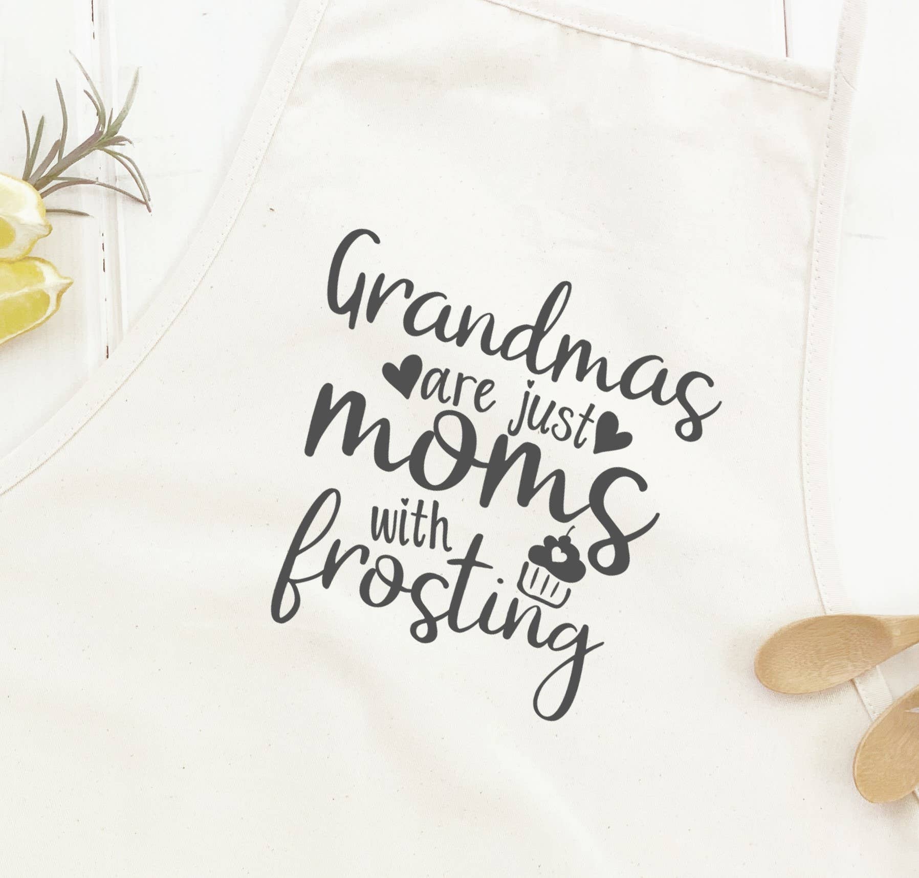 Grandmas Moms with Frosting Women's Apron featuring elegant design, cotton canvas fabric, and natural twill ties.