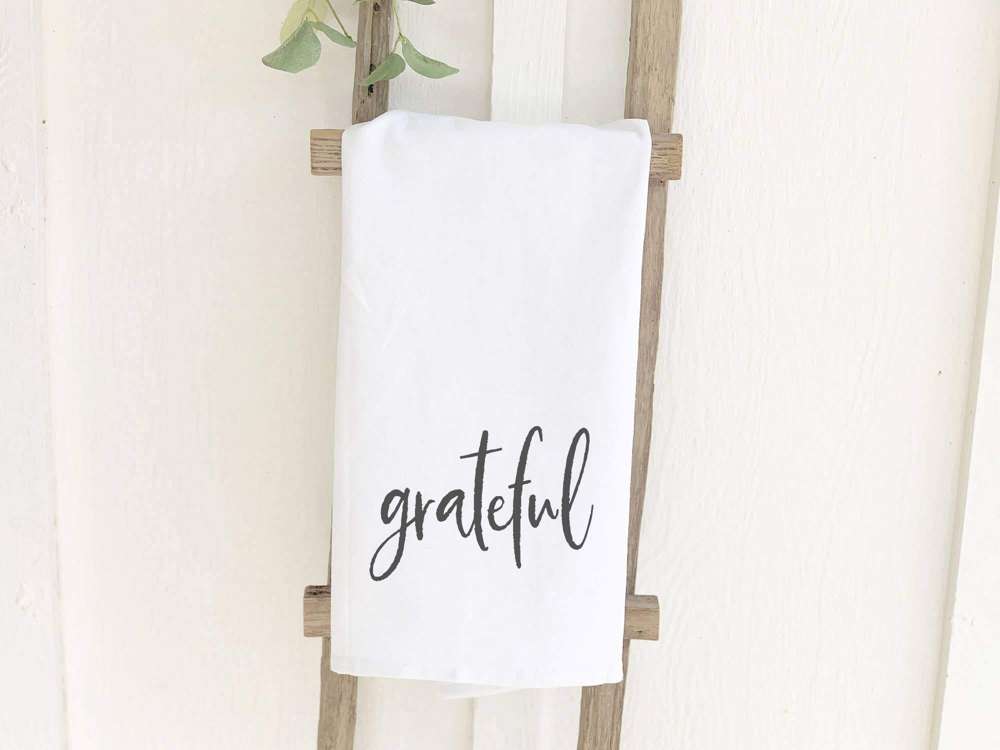 Grateful Cotton Tea Towel featuring vibrant colors and a beautiful design, perfect for kitchen use.