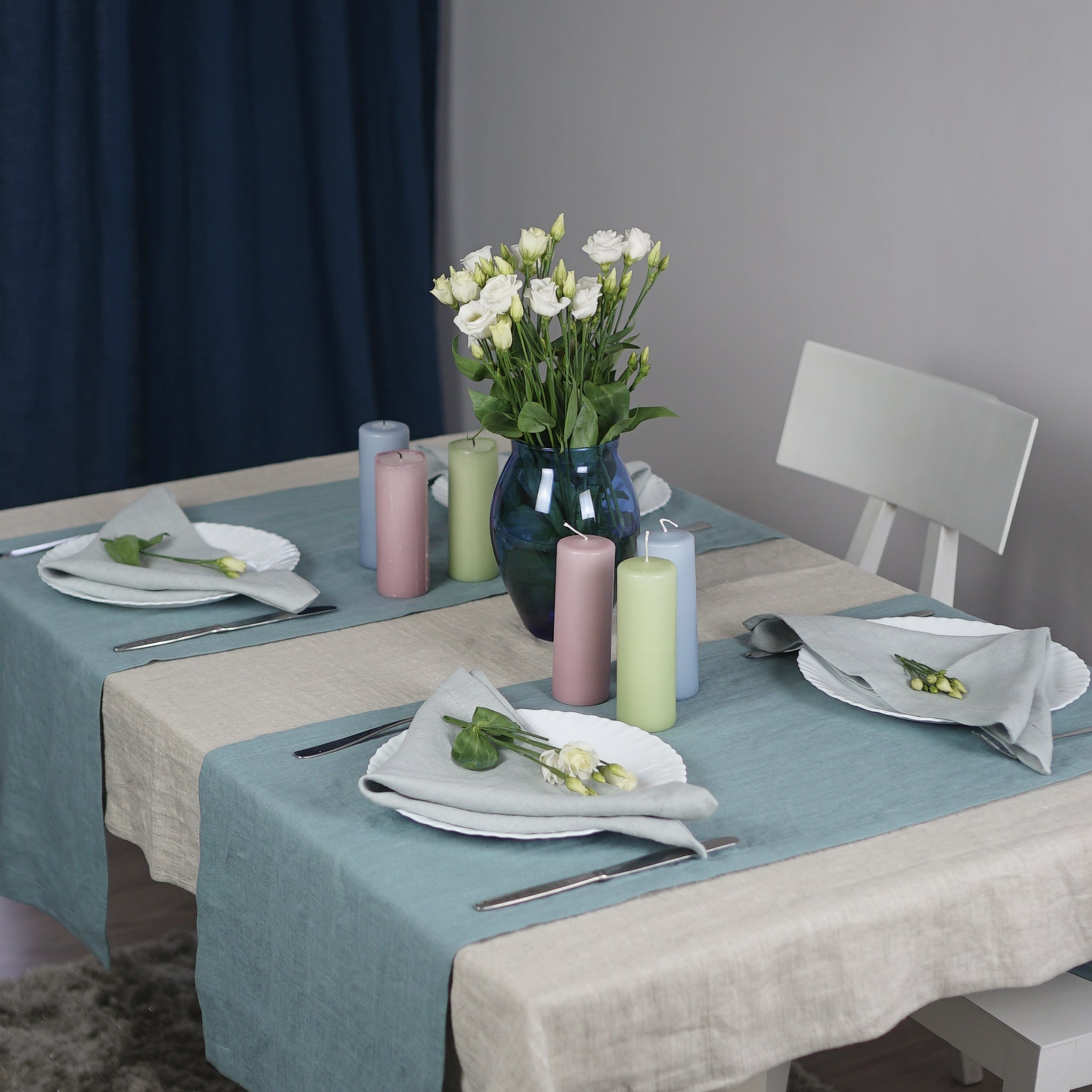 Greyish Mint linen table runner elegantly displayed on a dining table, showcasing its minimalist design and decorative hem.