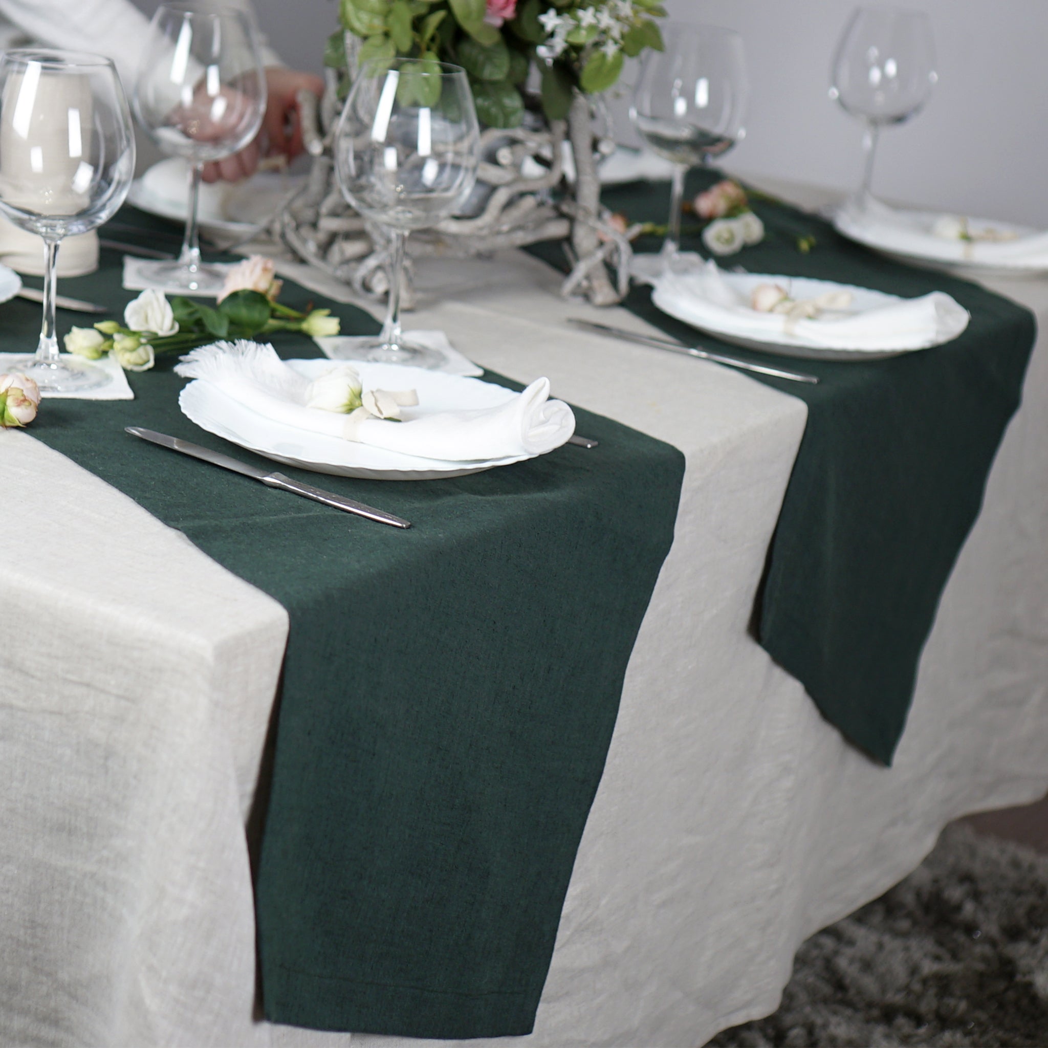 Greyish Mint linen table runner elegantly displayed on a dining table, showcasing its minimalist design and decorative hem.