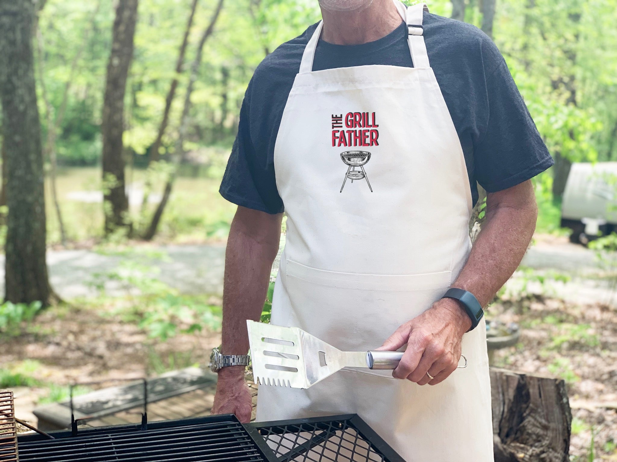 Grill Father Men's Apron featuring a humorous design, made from durable cotton canvas with adjustable neck and twill ties, perfect for grilling.