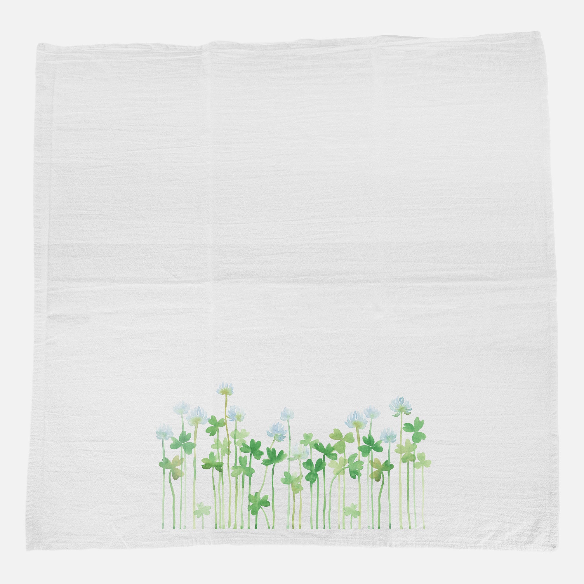 A vibrant cotton tea towel featuring a beautiful Growing Clover design, perfect for kitchen use.