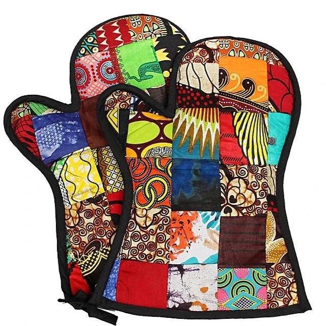 Handcrafted insulated oven gloves made from vibrant kitenge fabric, featuring a multi-colour patchwork design.