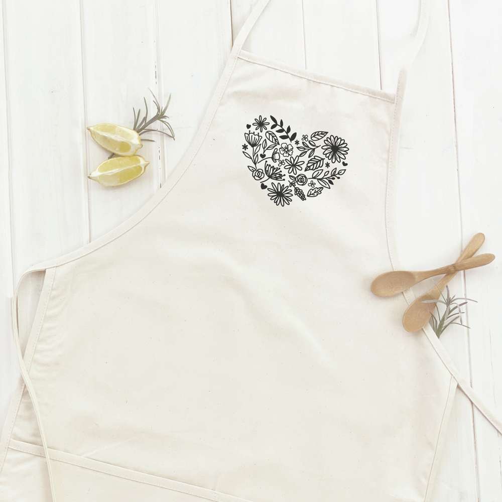 Heart of Flowers Women's Apron featuring elegant floral design, adjustable neck strap, and divided front pocket, made from durable cotton canvas.