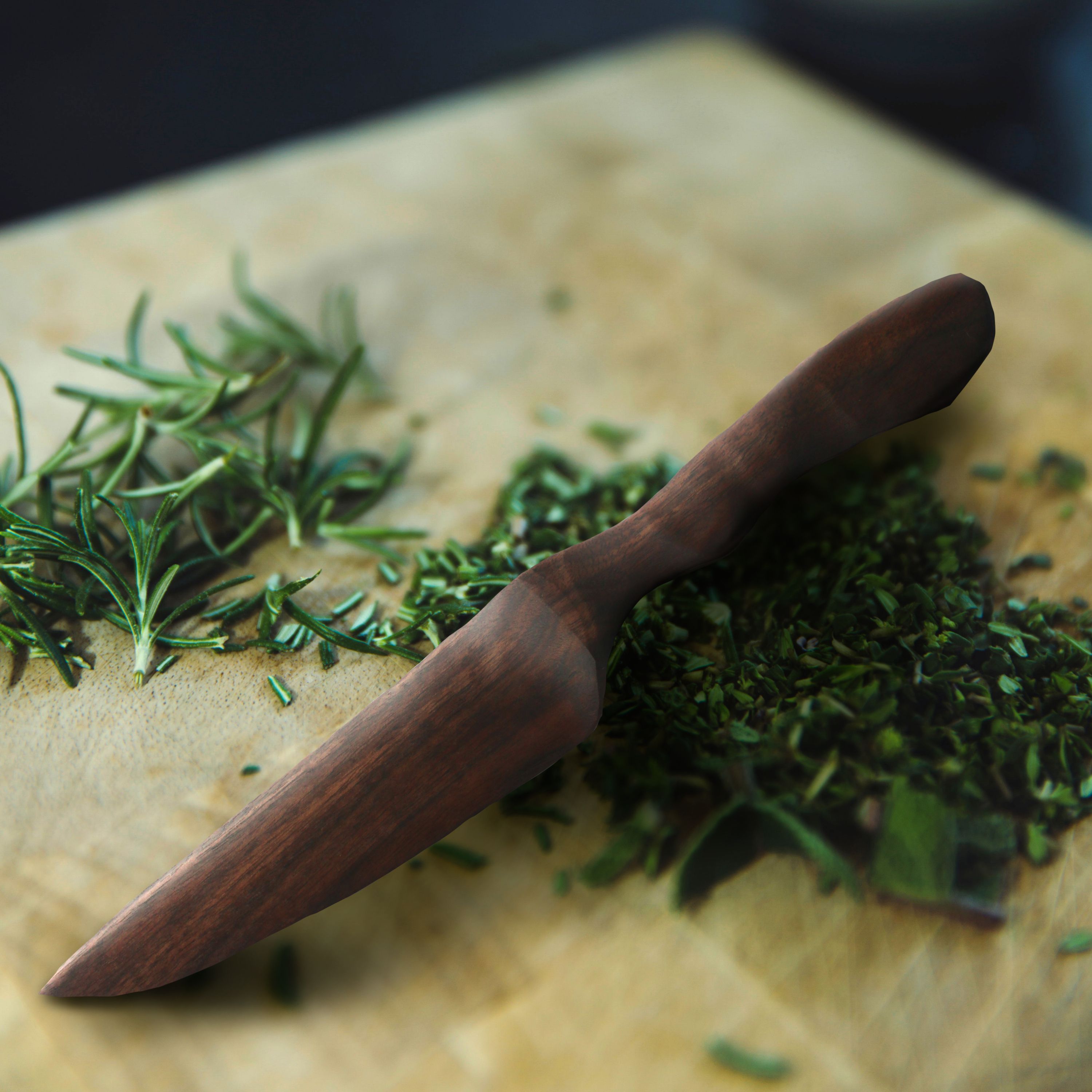 Herb & Vegetable Knife with a sharp wooden blade and chiseled handle, available in Walnut and Cherry finishes.