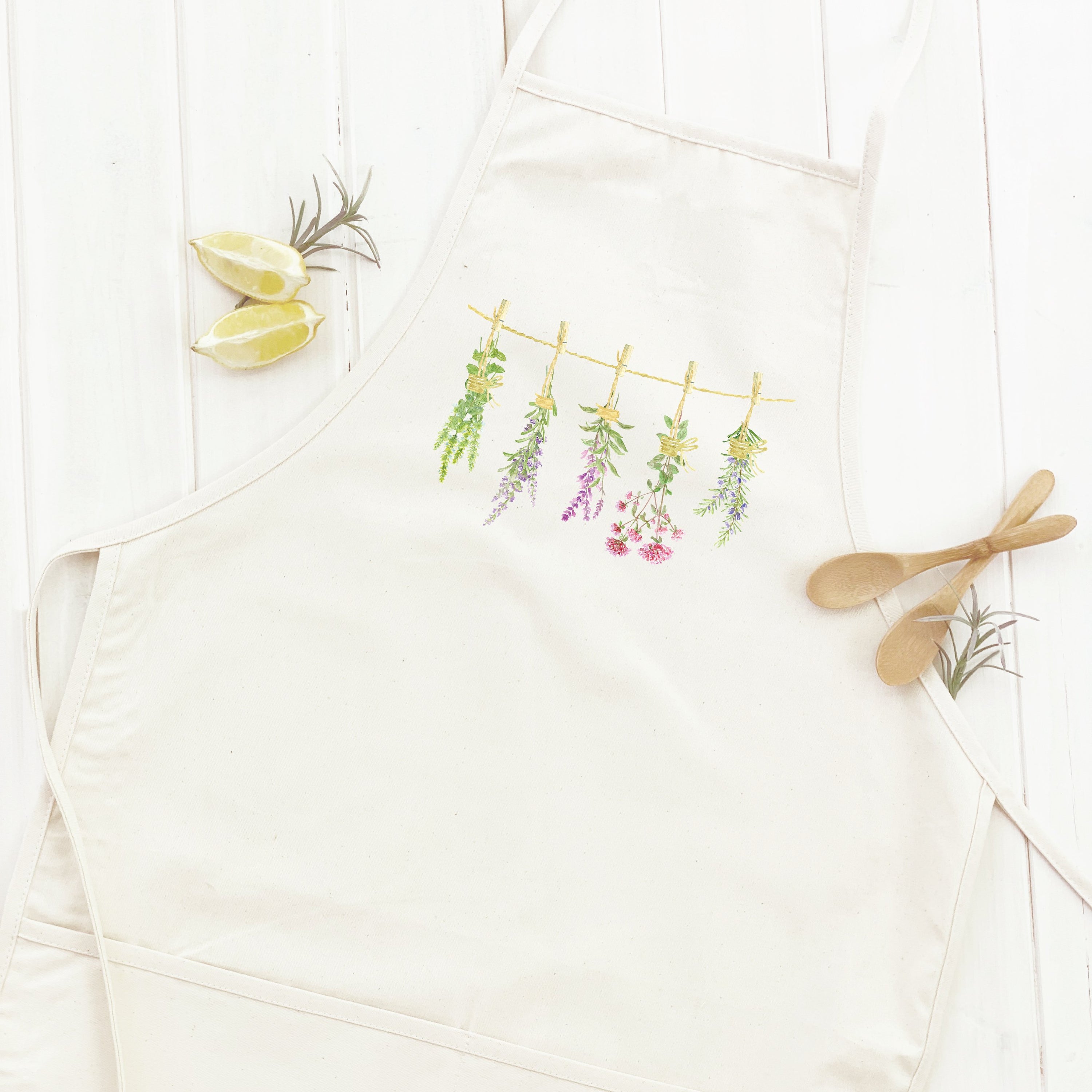 Herbs on a Line Women's Apron featuring elegant design, cotton canvas fabric, and adjustable neck ties.