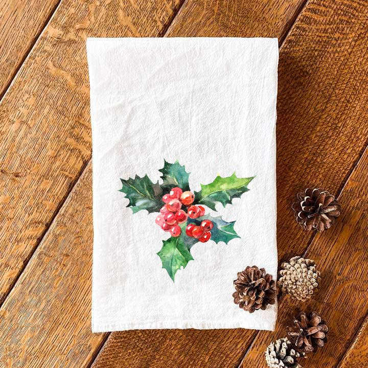 Holly and Berries cotton tea towel featuring vibrant colors and a festive design, perfect for kitchen use.