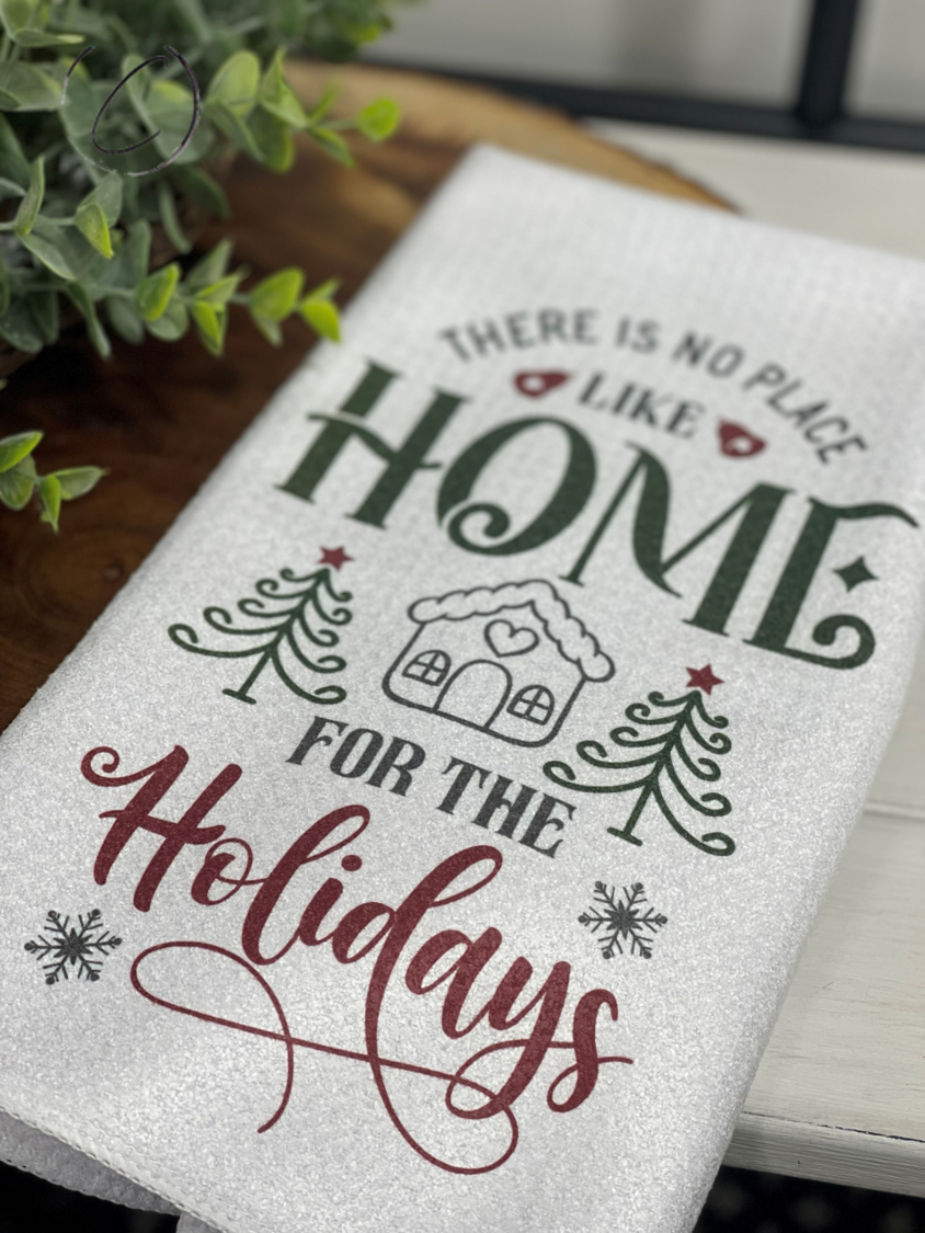 Home For The Holidays Waffle Weave Tea Towel featuring a festive design, measuring 16" x 24", ideal for kitchen and bathroom use.