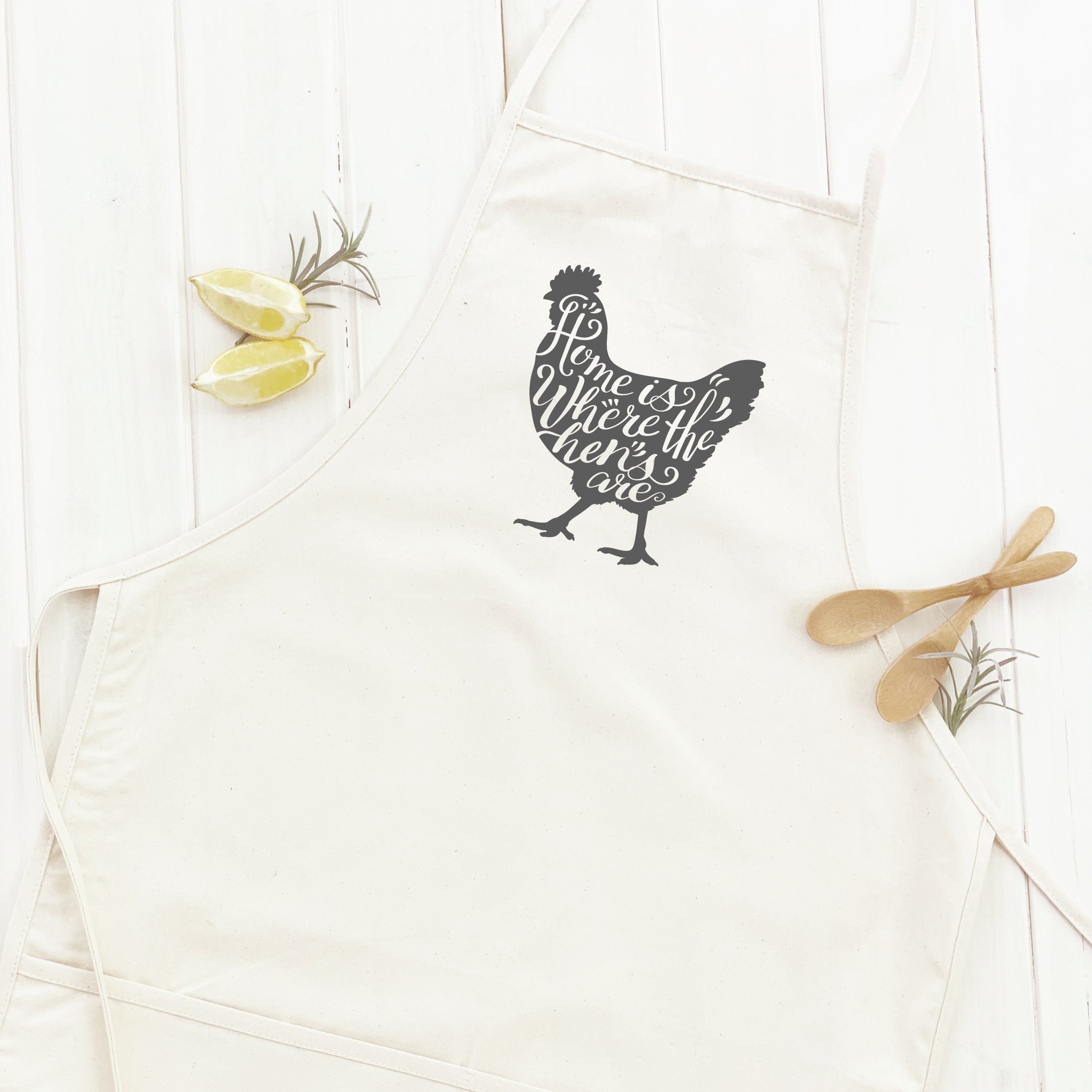 Home is Chicken Women's Apron made of cotton canvas with natural twill ties and a divided front pocket, featuring a stylish design.