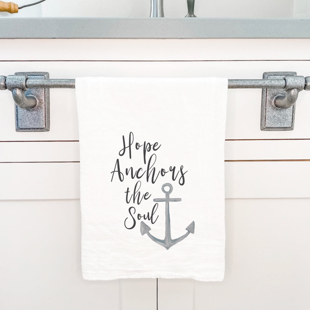 Hope Anchors the Soul cotton tea towel featuring a vibrant design, hemmed edges, and a 27-inch square size, perfect for kitchen use.