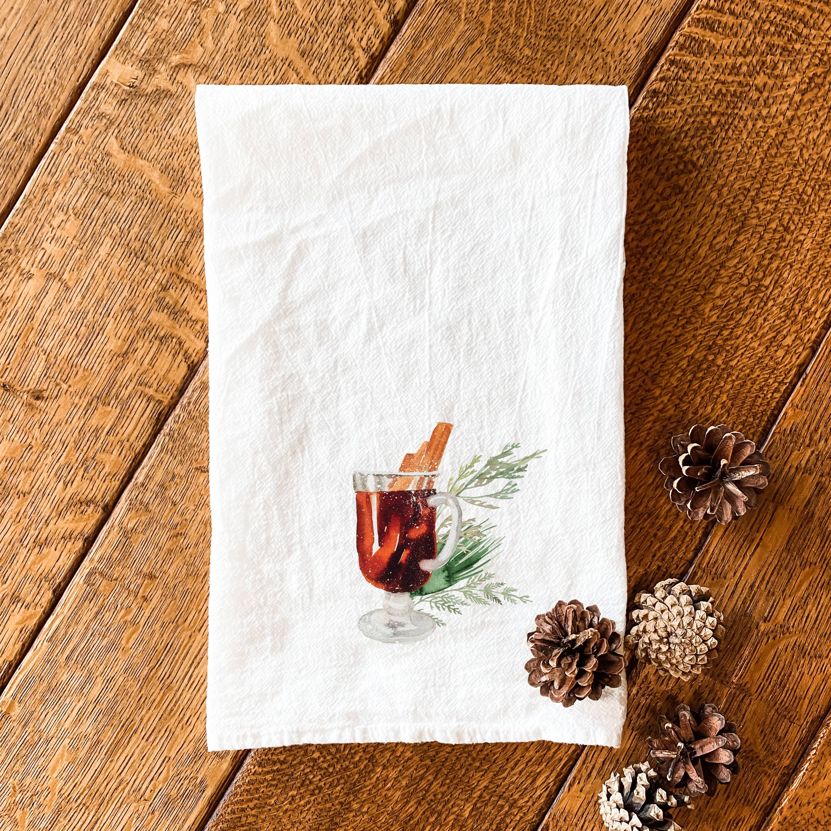 A vibrant Hot Cider Cotton Tea Towel featuring a cozy autumn design, made from 100% absorbent cotton, measuring 27 inches square.