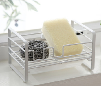 Household rack for kitchen sponges and brushes with a detachable drain basket, featuring a sleek white design and non-slip footpad.