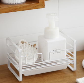 Household rack for kitchen sponges and brushes with a detachable drain basket, featuring a sleek white design and non-slip footpad.