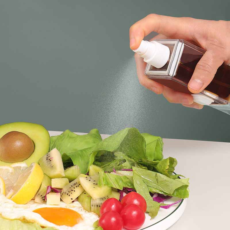 A transparent leak-proof oil bottle made from Tritan, designed for kitchen use, showcasing its compact size and sleek design.