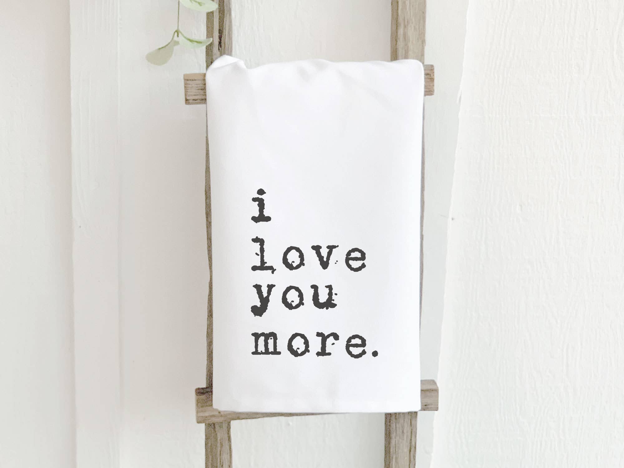 I Love You More Cotton Tea Towel featuring vibrant design and hemmed edges, perfect for kitchen use.