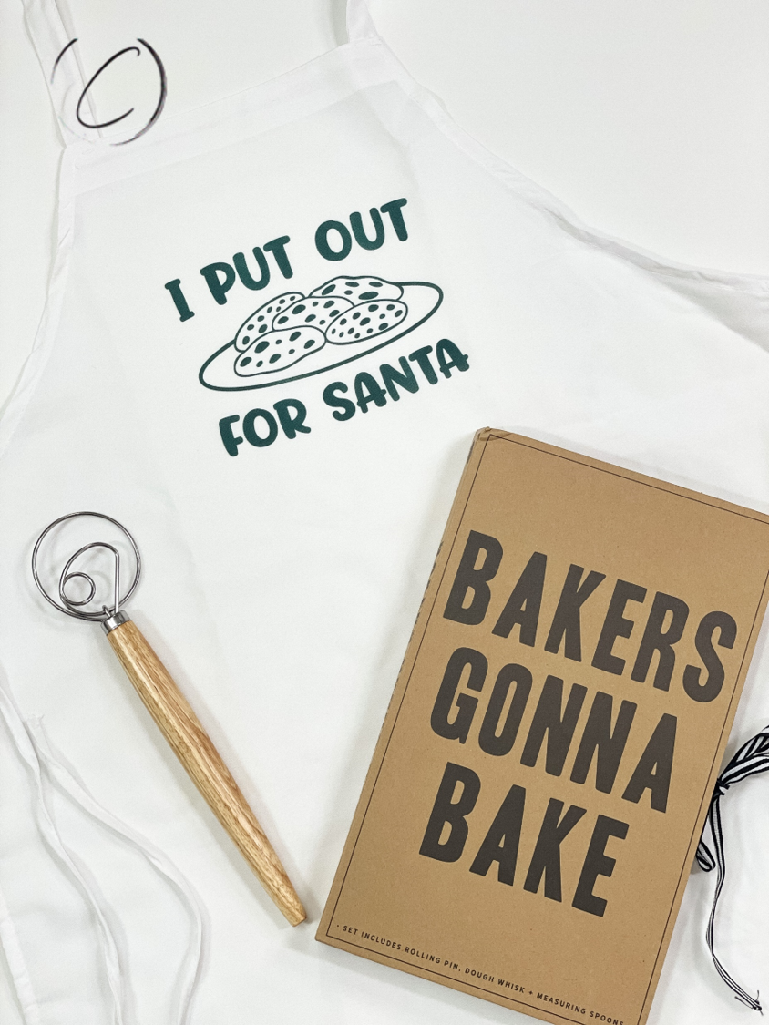 I Put Out For Santa Apron featuring a humorous design, made from soft brushed filament polyester with long waist ties.