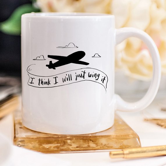 A humorous coffee mug featuring the phrase 'I Think I Will Just Wing It', designed for pilots and coffee lovers, showcasing a fun and playful design.