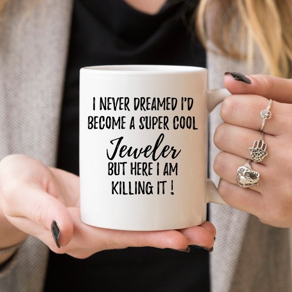 A white ceramic mug featuring a vibrant jewelry-themed design, perfect for jewelers, shown against a neutral background.