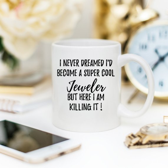 A white ceramic mug featuring a vibrant jewelry-themed design, perfect for jewelers, shown against a neutral background.