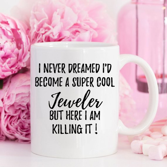 A white ceramic mug featuring a vibrant jewelry-themed design, perfect for jewelers, shown against a neutral background.