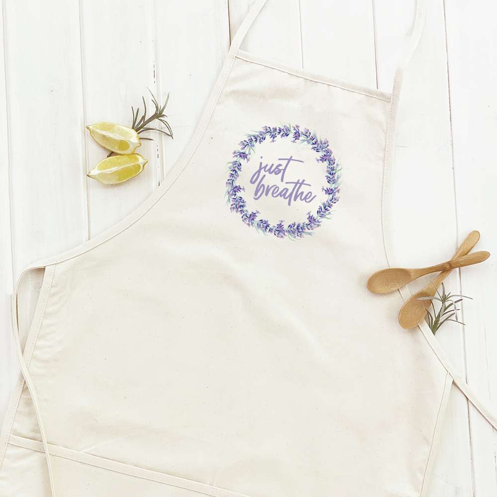 Just Breathe Women's Apron in cotton canvas with natural twill ties and divided front pocket, showcasing its elegant design.