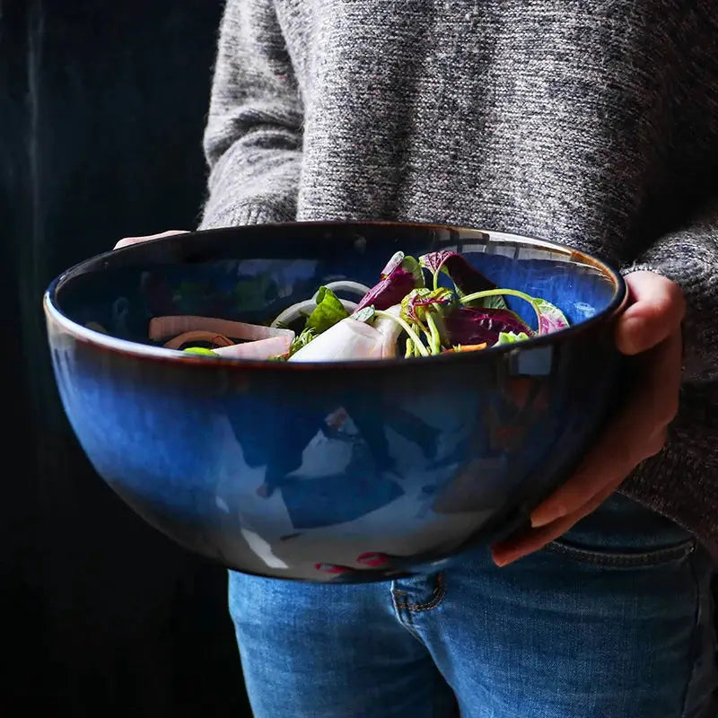 A handcrafted ceramic Kaia bowl in a subtle blue shade, ideal for serving sushi, ramen, and miso soup, showcasing its elegant and minimalist design.