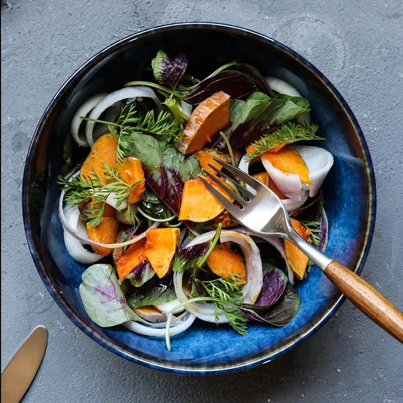 A handcrafted ceramic Kaia bowl in a subtle blue shade, ideal for serving sushi, ramen, and miso soup, showcasing its elegant and minimalist design.