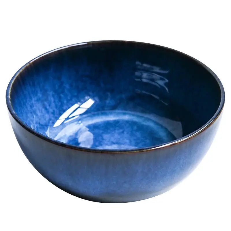 A handcrafted ceramic Kaia bowl in a subtle blue shade, ideal for serving sushi, ramen, and miso soup, showcasing its elegant and minimalist design.